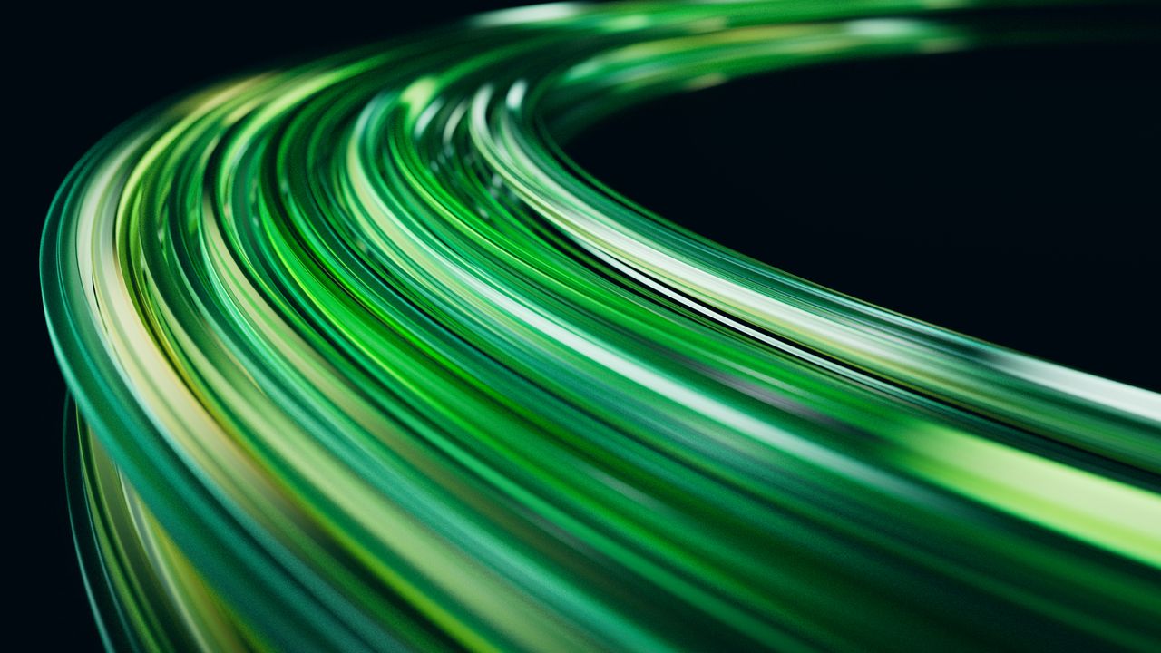 Home Abstract image of green light trails on a dark background, creating a sense of motion.